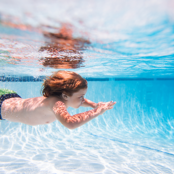 young boy swimming underwater